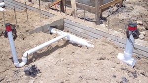 How deep are plumbing pipes under a slab house